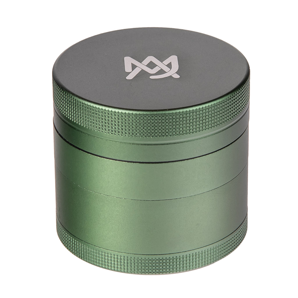 Four-piece MJ Arsenal aluminum grinder with kief catcher for smooth vaporizer sessions.